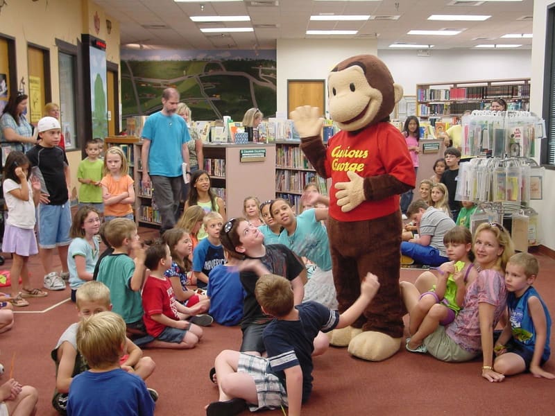 Children at story time with a costumed character