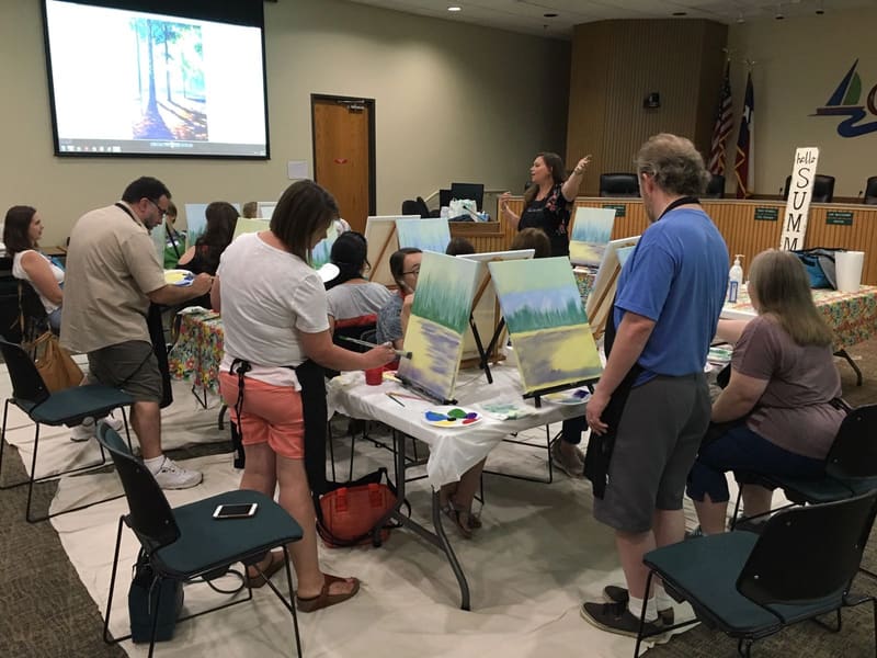Visitors trying out computers and technology at the library